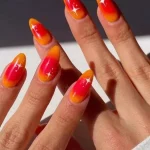 The Sunset Aura Manicure Trend Brings Endless Summer Energy to Your Nails