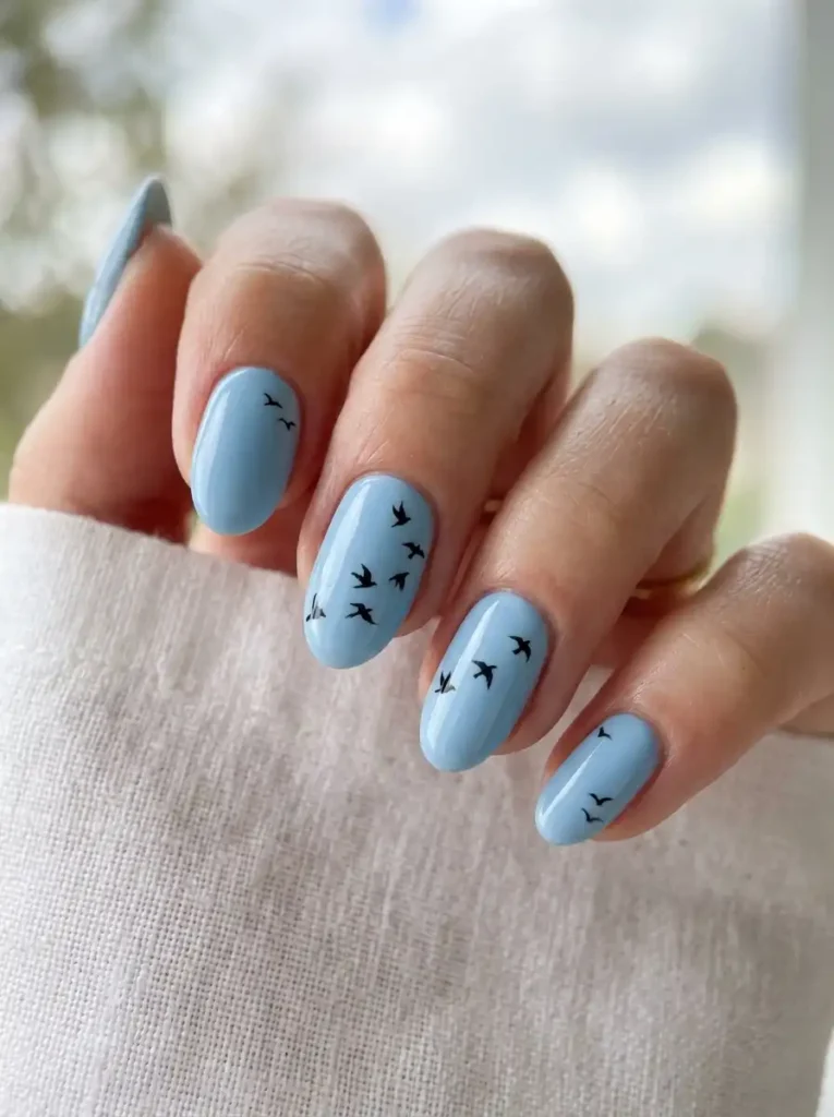 Avian inspired nail art on oval nails.