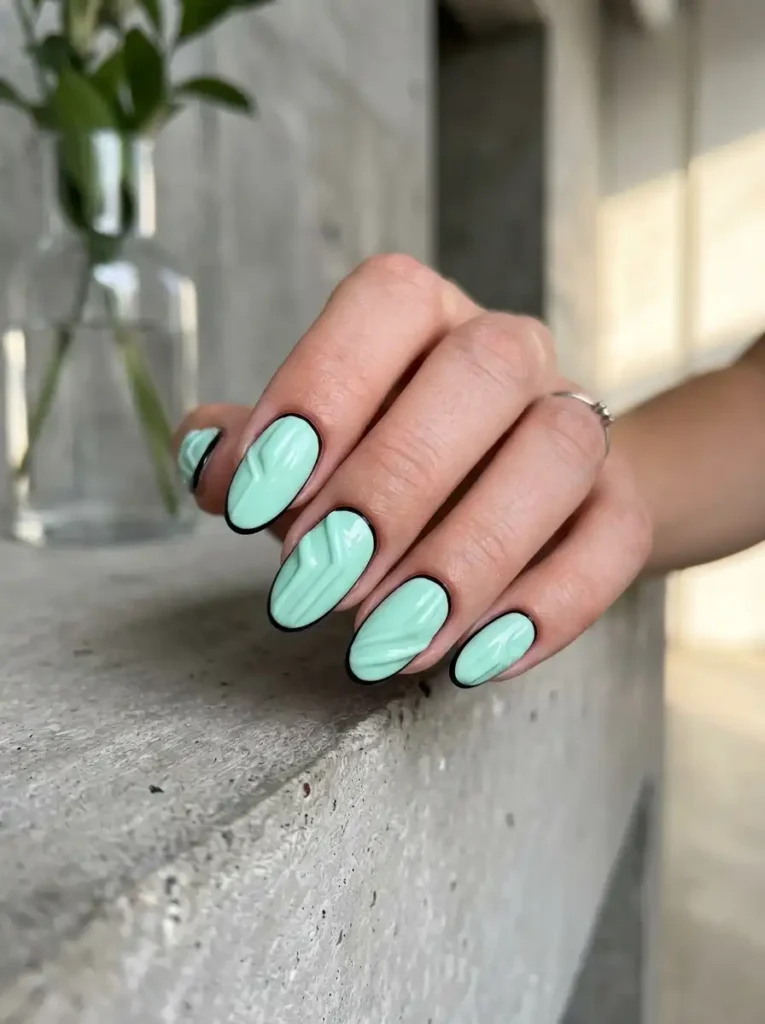3D pastel nail designs for oval nails with black outlines.